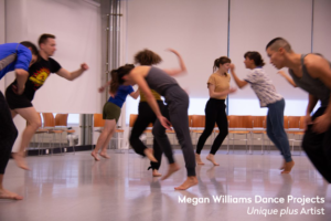 Eight dancers in a studio, in motion and slightly blury from running movements