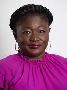 Black woman with hoop earrings wearing fuchsia blouse